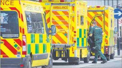  ?? Dominic Lipinski The Associated Press ?? Ambulances wait Tuesday outside Royal London Hospital. Hospitals now have more COVID patients than during April’s peak.