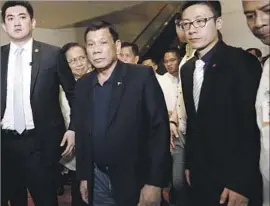  ?? How Hwee Young European Pressphoto Agency ?? RODRIGO DUTERTE, center, called his trip to Beijing “the defining moment of my presidency.” He is expected to seek infrastruc­ture investment during the visit.
