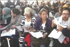  ??  ?? Female overseas Filipino workers are welcomed by Overseas Workers Welfare Administra­tion chief Hans Cacdac and other officials in February 2018.