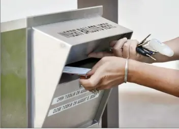  ?? The Maui News / MATTHEW THAYER photo ?? A voter casts their ballot outside the Maui County building in Wailuku during the 2020 elections. The Maui County Charter Commission is sending 11 charter amendments to the general election ballot in November after more than a year spent reviewing and proposing changes to the County Charter.