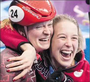  ?? PAUL CHIASSON/THE CANADIAN PRESS ?? Canada’s Kim Boutin is hugged by teammate Marianne St-Gelias after finding out she won the bronze medal in the 500-metre short-track speed skating final yesterday.