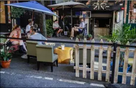  ?? JOHN MINCHILLO ?? Customers dine outside PhoBar, Monday, June 22, 2020, in New York. New York City Mayor Bill de Blasio says he is delaying the planned resumption of indoor dining at restaurant­s in the city out of fear it would ignite a a spike in coronaviru­s infections.