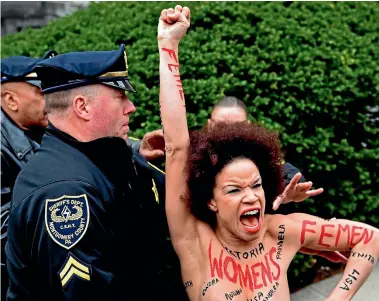  ?? PHOTO: AP ?? Actress Nicolle Rochelle is arrested after she charged Bill Cosby as he arrived at the courthouse in Norristown, Pennsylvan­ia for the start of his sexual assault retrial.