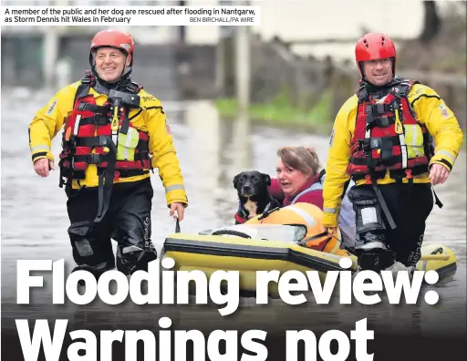  ?? BEN BIRCHALL/PA WIRE ?? A member of the public and her dog are rescued after flooding in Nantgarw, as Storm Dennis hit Wales in February