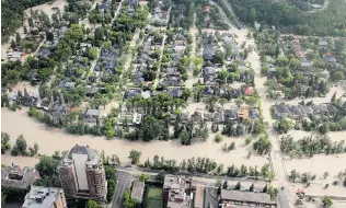  ?? TED RHODES/ POSTMEDIA NEWS FILES ?? ONE YEAR AGO: The inner- city community of Roxboro is underwater east of 4th Street and adjacent to the Elbow River on June 21, 2013.