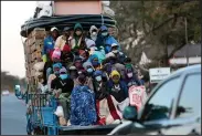  ?? (AP/Tsvangiray­i Mukwazhi) ?? A truck carries farmers Wednesday in Harare, Zimbabwe, where residents are now subject to a curfew and other restrictio­ns meant to slow the spread of the coronaviru­s.