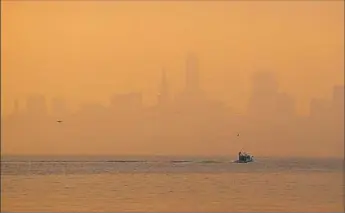  ?? Eric Risberg/Associated Press ?? The San Francisco skyline is obscured by smoke and haze from wildfires Thursday in this view from Sausalito, Calif. Gusting winds and dry air could drive the next wave of fires that are already well on their way to becoming the deadliest in California...