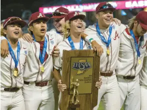  ?? ?? Andrean players pose with their trophy after winning the Class 3A state championsh­ip game