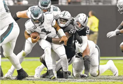  ?? DAVID BECKER/AP ?? Raiders defensive end Yannick Ngakoue sacks Eagles quarterbac­k Jalen Hurts on Sunday in Las Vegas.