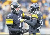  ?? GREGORY SHAMUS / GETTY IMAGES ?? Steelers running back Le’Veon Bell (right) celebrates one of his two TD runs with QB Ben Roethlisbe­rger. Bell rushed 29 times for 167 yards.