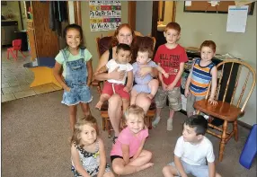  ?? RACHEL DICKERSON/MCDONALD COUNTY PRESS ?? Allie Peck, center, is surrounded by children who attend her daycare, Stepping Stones, in Noel.