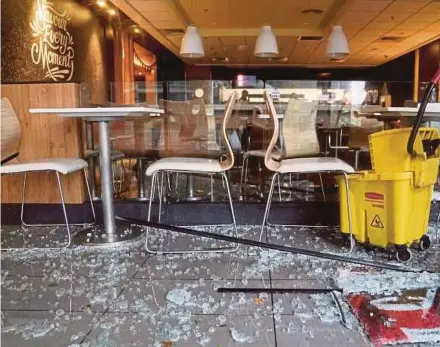  ?? REUTERS PIC ?? Broken glass from a gate in a restaurant seen in the wake of Typhoon Mangkhut making landfall in Guangdong province, Shenzhen, yesterday.