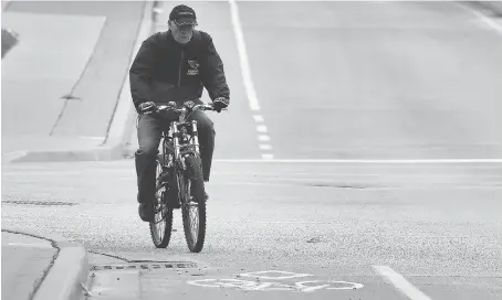  ?? DAN JANISSE ?? A cyclist uses a designated bike lane on Wyandotte Street East near Riverdale Avenue in Windsor on Monday after the province announced $3 million in funding for local cycling infrastruc­ture. The city is waiting to hear from the province which of its...