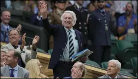  ?? ASSOCIATED PRESS ?? Rugby legend JPR Williams waves as he stands in the Royal Box after being introduced on Centre Court at the Wimbledon tennis championsh­ips in London, on July 8.