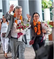  ?? ?? Tourists, wearing welcome garlands, exit Bali Ngurah Rai Internatio­nal Airport in Bali, Indonesia, on 22 January