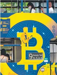  ?? Photo: AP ?? An advertisem­ent for bitcoin on a tram in the city. Hong Kong is making an ambitious push to become a hub for virtual assets.