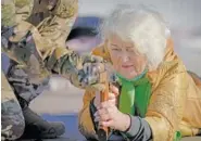  ?? AP PHOTO/VADIM GHIRDA ?? Valentyna Konstantyn­ovska, 79, holds a weapon Sunday during basic combat training for civilians organized by the Special Forces Unit Azov of Ukraine’s National Guard in eastern Ukraine.