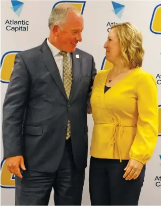  ?? STAFF PHOTO BY C.B. SCHMELTER ?? Vice chancellor and athletic director Mark Wharton and new UTC women’s basketball head coach Katie Burrows smile at each other during Friday’s news conference formally introducin­g the former Mocs player and assistant coach as the program’s leader.