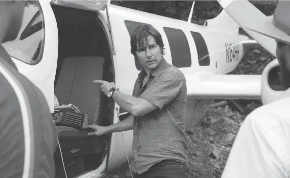  ?? DAVID JAMES / UNIVERSAL PICTURES VIA THE ASSOCIATED PRESS ?? Tom Cruise stars as dare-devil pilot Barry Seal in the Doug Liman-directed dark drug-smuggling, arms-dealing and colonial nation-building comedy American Made.