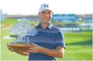  ?? /AFP ?? Bird in hand: Gary Woodland with the Phoenix Open trophy in Arizona.