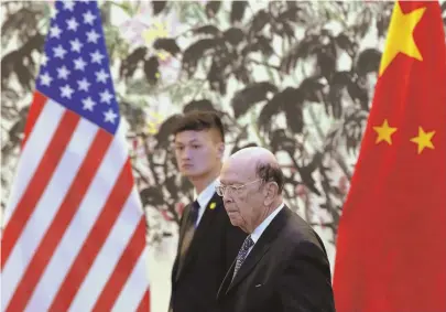  ?? AP PHOTOS ?? IMPORTS AND EXPORTS: U.S. Commerce Secretary Wilbur Ross, above right and second from left, below, meets with Chinese Vice Premier Liu He, fourth from right below, in Beijing yesterday on trade talks.