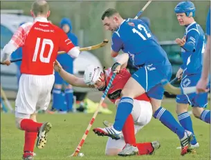  ?? Photograph: Donald Cameron. ?? Unorthodox defending from Adam MacMaster as Kilmallie’s Duncan Rodger gets his swing in.