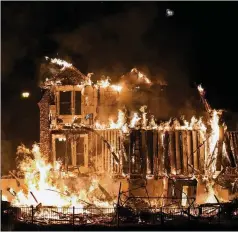  ?? DAVID ZALUBOWSKI/AP ?? Homes burn as a wildfire rips through a developmen­t near Broomfield, Colo. An estimated 580 homes, a hotel and a shopping center have burned and tens of thousands of people were evacuated.