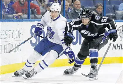  ?? AP PHOTO ?? In this March 16 file photo, Toronto Maple Leafs centre Auston Matthews (left) gets around Tampa Bay Lightning defenseman Jake Dotchin during the third period of an NHL game in Tampa, Fla.