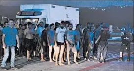  ?? GETTY-AFP ?? Survivors thought to be migrants line up near an ambulance Wednesday in Turkey.