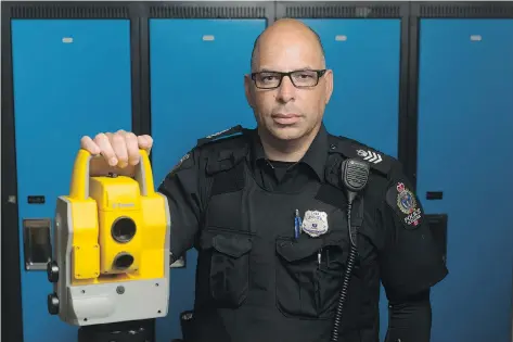  ?? MICHAEL BELL ?? Sgt. Andrew Puglia of the Regina Police Service stands with survey equipment at headquarte­rs. The equipment is used to analyze traffic accidents, of which Puglia has investigat­ed many in his career.