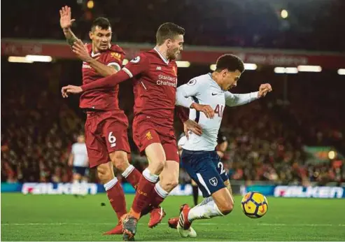  ?? EPA PIC ?? Tottenham’s Dele Alli (right) dives in the penalty area in a Premier League match against Liverpool at Anfield on Sunday.