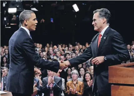  ?? MICHAEL REYNOLDS, AP ?? President Obama shakes hands with Republican nominee Mitt Romney on Wednesday after their debate in Denver.