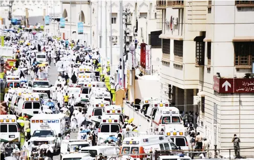  ?? PHOTO AFP ?? Saudi ambulances arrive with pilgrims who were injured in a stampede at an emergency hospital in Mina, near the holy city of Mecca, on the first day of Eid al-Adha yesterday. At least 717 people were killed and hundreds wounded during a stampede.