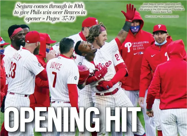  ?? MATT SLOCUM — THE ASSOCIATED PRESS ?? Jean Segura, center, celebrates with teammates after hitting a game-winning RBI single in the 10th inning on Thursday at
Citizens Bank Park.