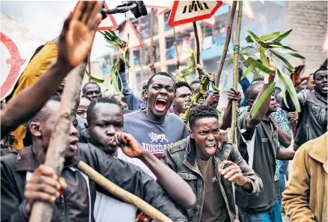  ??  ?? Supporters of Kenyan presidenti­al candidate Raila Odinga protest in the slums of Nairobi after he claimed a massive hacking attack had manipulate­d election results.