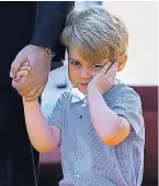  ??  ?? Wearing blue to match her mother, Princess Charlotte, left, looked delighted with her mini posy of flowers, a gift from the German government. Prince George, above, appeared reluctant to be in the limelight, holding his father’s hand as the royal party...