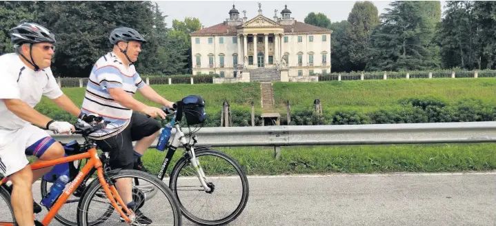  ??  ?? ●●Andrew and Lawrence cycling past a mansion on the way to Venice
