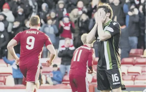  ??  ?? Lewis Stevenson can’t bear to look as No 11 Gary Mackay-steven celebrates one of the three goals he scored against Hibs last week.