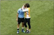  ?? HASSAN AMMAR — THE ASSOCIATED PRESS ?? Uruguay’s Edinson Cavani embraces teammate Luis Suarez, left, at the end of the quarterfin­al match between Uruguay and France at the 2018 soccer World Cup in the Nizhny Novgorod Stadium, in Nizhny Novgorod, Russia, Friday.