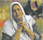  ?? FAREED KHAN ASSOCIATED PRESS ?? Rita Raja, mother of Arzoo Raja, prays for her daughter’s return. Arzoo was 13 when she was taken from her home in Karachi. Though she has been found, the Christian girl fears leaving her husband’s Islamic family.