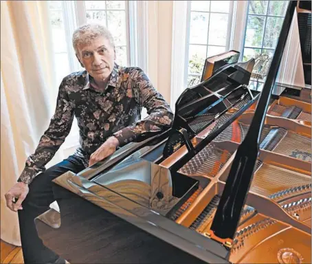  ?? PHIL VELASQUEZ/CHICAGO TRIBUNE ?? Songwriter Dennis DeYoung with his piano at his west suburban home in 2014. He also has a recording studio in the basement.