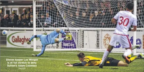  ?? FM4716781 ?? Stones keeper Lee Worgan is at full stretch to deny Sutton’s Adam Coombes