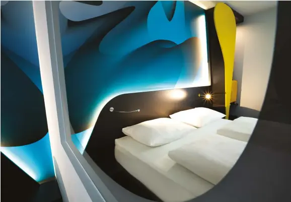 ??  ?? ABOVE: Combining “comfort, colour, enthusiasm and luxury at a budget price,” Karim Rashid’s interiors for the European hotel chain Prizeotel reflect his espousal of high design for all. The suite pictured here is in Erfurt, Germany.