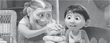  ?? — Walt Disney Pictures-Pixar Animation Studios photo ?? In Disney/Pixar’s ‘Coco’, Abuelita (Renée Victor) serves Miguel (Anthony Gonzalez) what’s piping hot.