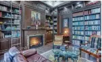  ??  ?? Double French doors open to the library with a coffered ceiling and floor-to-ceiling cabinetry.