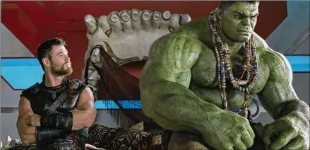  ?? ASSOCIATED PRESS ?? Chris Hemsworth (left), sitting here with the Hulk, stars as Thor in “Thor: Ragnarok.”