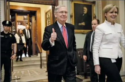  ?? The Associated Press ?? NUCLEAR OPTION: Senate Majority Leader Mitch McConnell of Ky. signals a thumbs-up Thursday as he leaves the Senate chamber on Capitol Hill in Washington after he led the GOP majority to change Senate rules and lower the vote threshold for Supreme Court...