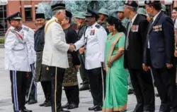  ??  ?? Najib shaking hands with Special Branch F Team sub-inspector Sridharan Sandu Nair, who was accompanie­d by his wife S. Meenachi, during the event in Putrajaya yesterday. At left is Mohamad Fuzi.