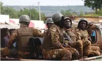  ?? (Luc Gnago/Reuters) ?? SOLDIERS SECURE the road for President Ibrahim Boubacar Keita in Bamako yesterday after he casted his vote.