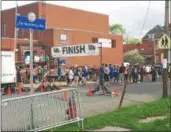  ?? RECORD FILE PHOTO ?? People gather outside the Lansingbur­gh Boys and Girls Club on Joe Manupella Way before the second annual Joseph G. Manupella Memorial Run kicked off.